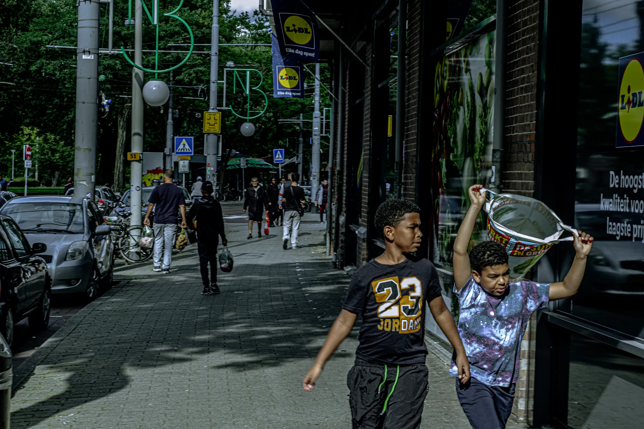 Street photography in the Netherlands Rotterdam Binnenweg two boys at the supermarket.