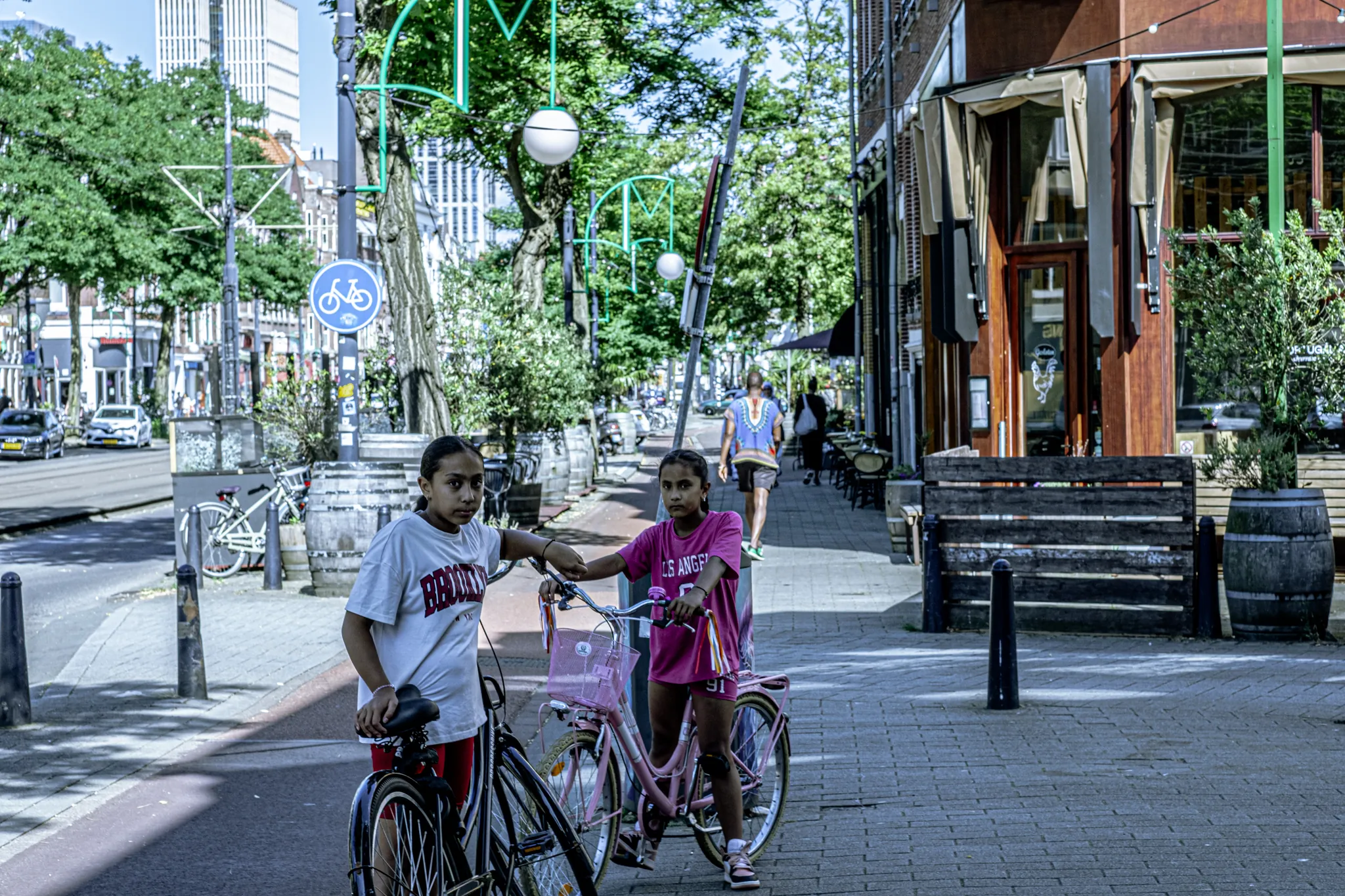 Street photography in the Netherlands Rotterdam binnenweg two girls with a bike.