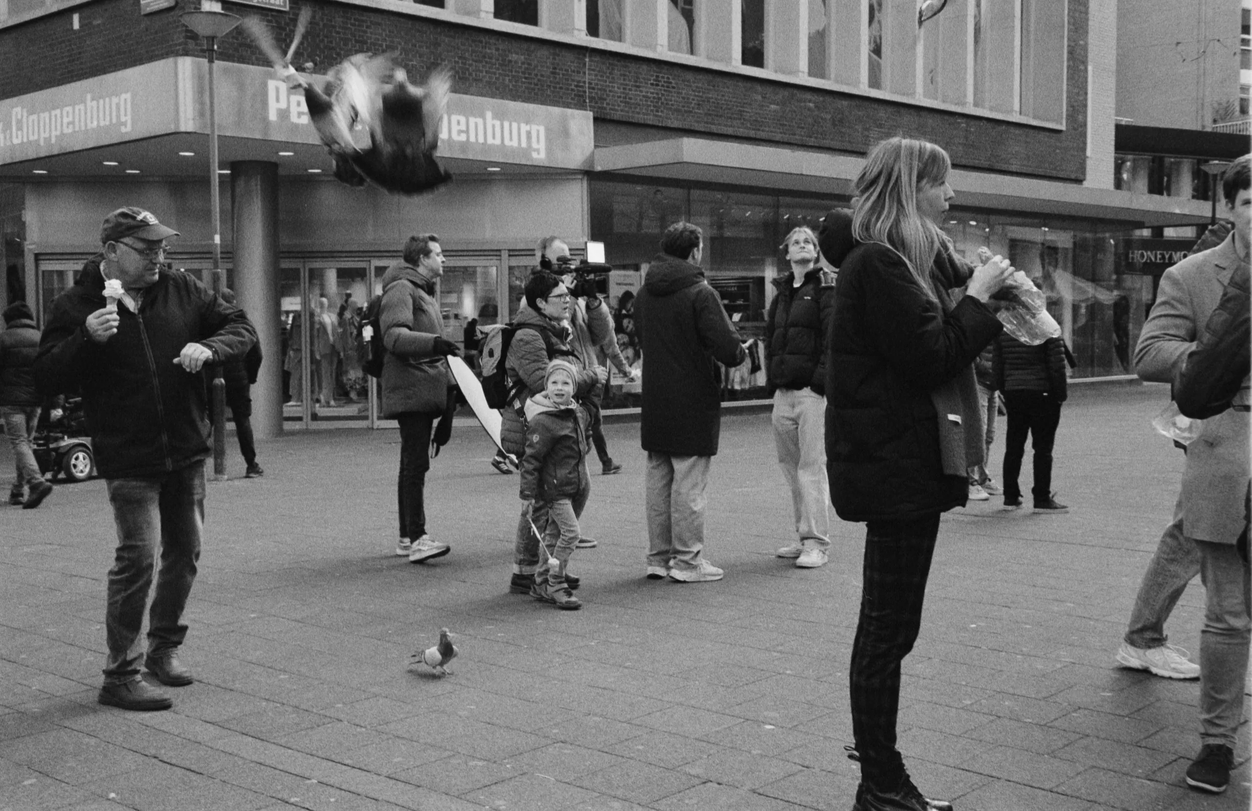 Street photography in the Netherlands Rotterdam close to koopgoot of people and birds in layers B&W kodak tmax 400.