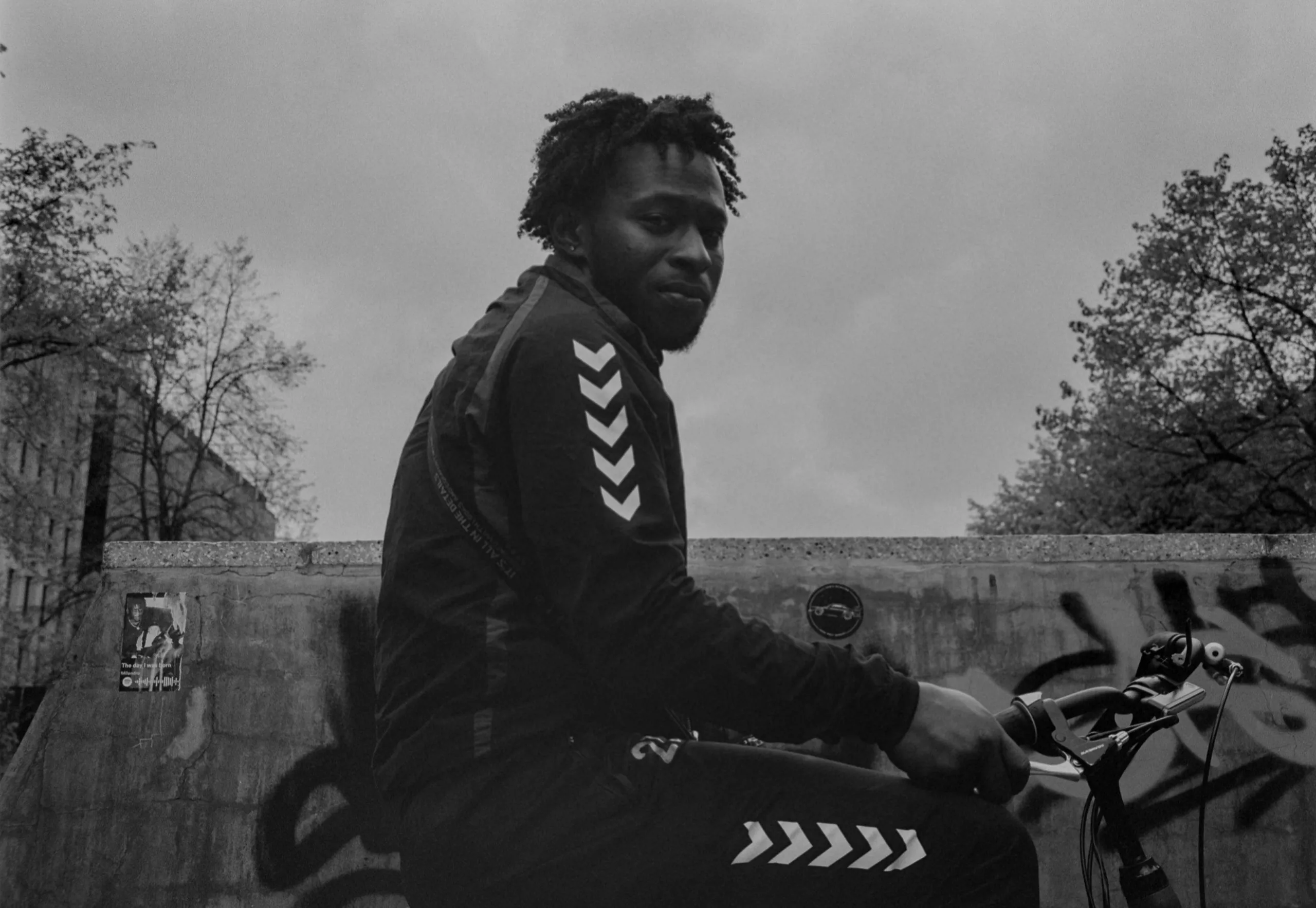 Street photography portrait in the Netherlands Rotterdam skatepark of a man with a bike on medium format film B&W taken on a fuji ga645.