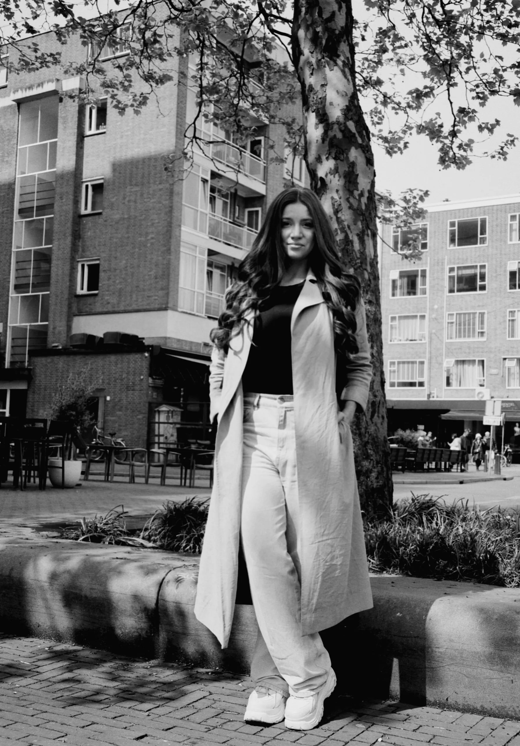 Street photography portrait in the Netherlands Rotterdam of a woman posing on a market on medium format film B&W taken on a fuji ga645.