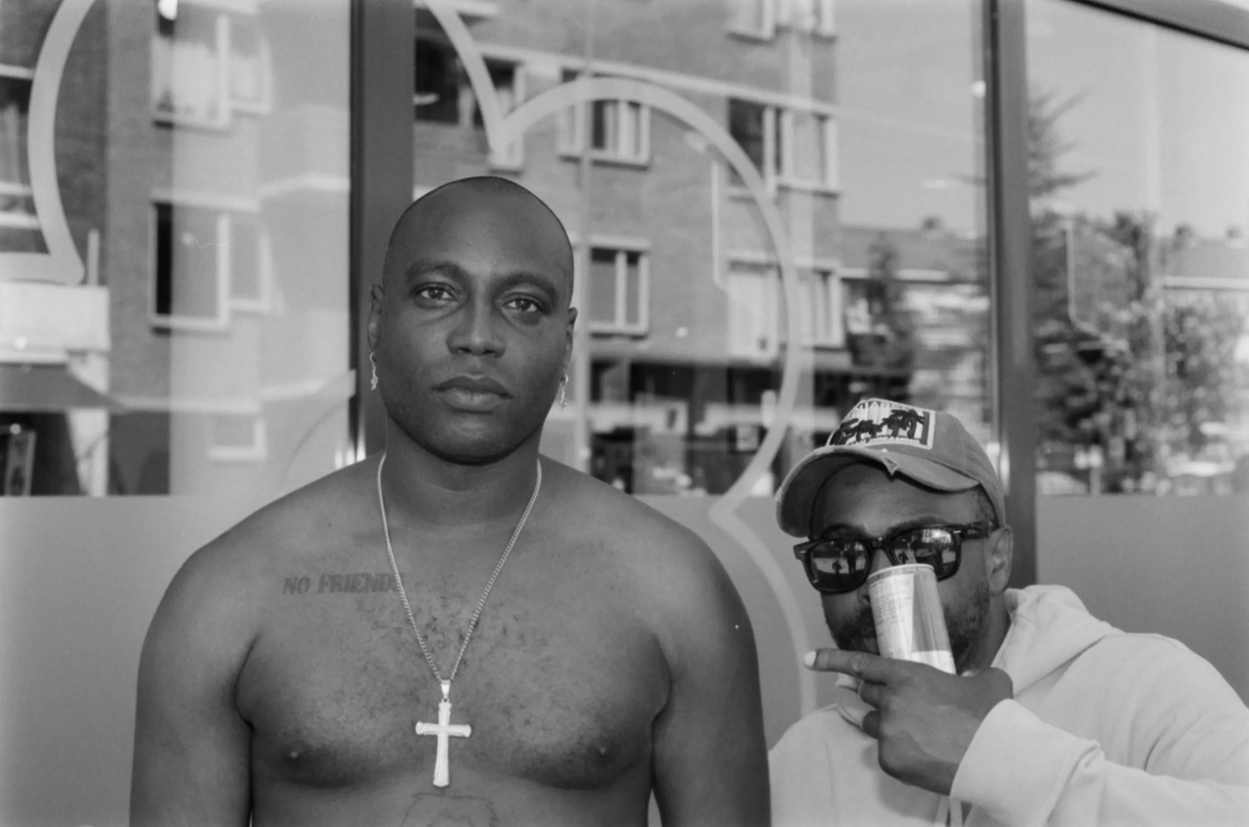 Street photography portrait in the Netherlands Rotterdam of two man posing on B&W film with flash 35mm ilford delta 400 film.