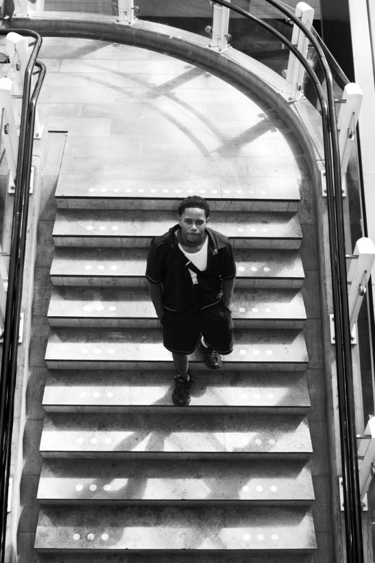 Man posing at stairs at station blaak shot on fuji XE-3 with flash.