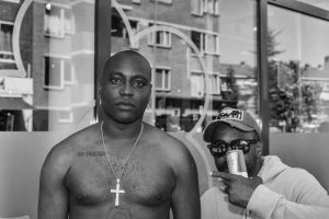 Street portret of a man with tattoo"No friends" in Rotterdam.