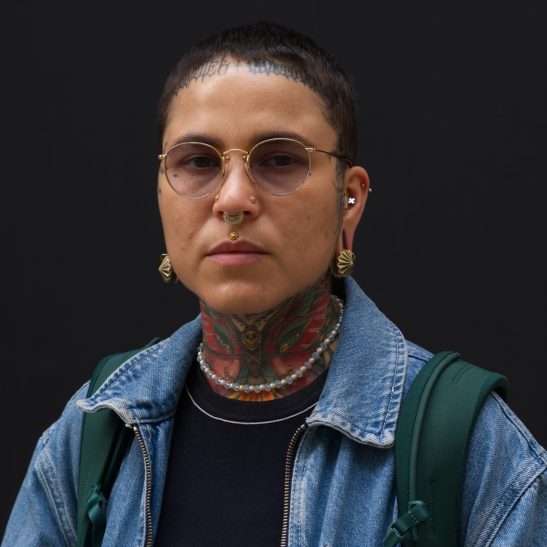 Portrait of a woman with tattoo's in Rotterdam shot with a Fuji XE-3 on camera flash.