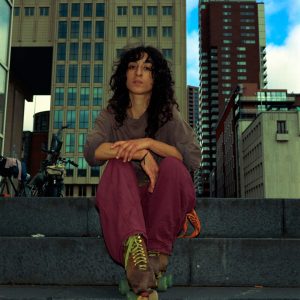 Portrait of a woman doing urban sports in Rotterdam taken on a Fuji GA645 medium format film kodak gold 200 with flash on camera.