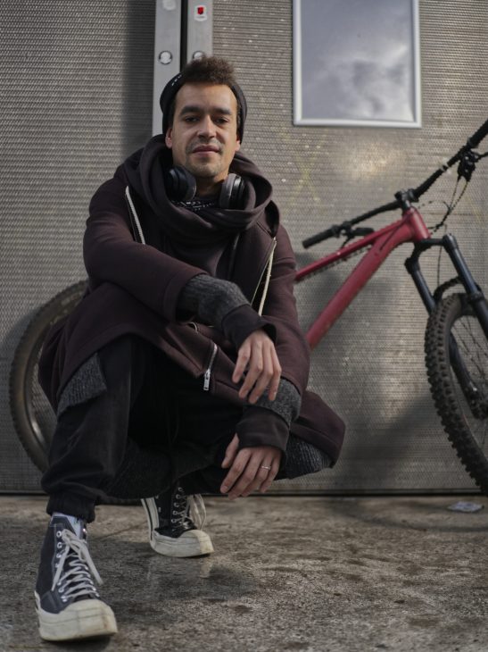 Portrait of @iamvinnah instagram of a man posing in front of a fuji gfx50s 63mm with off camera flash.